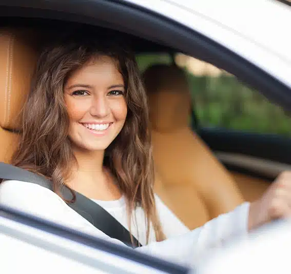 Young woman driving her car