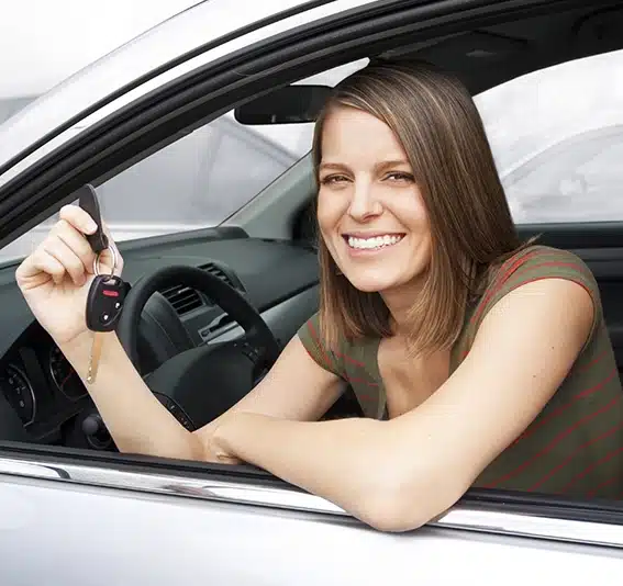 Woman in a car holding a key