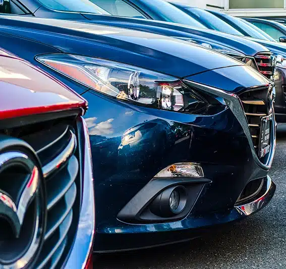 A row of Mazda 3s at a dealership