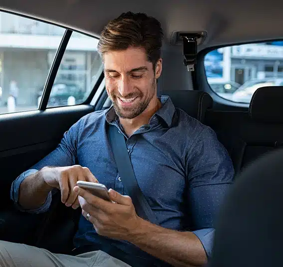 Man in a car using his mobile phone