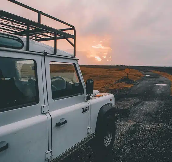 White SUV on black dirt