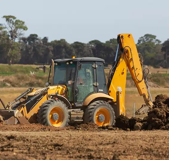 A bulldozer digging dirt in a field
