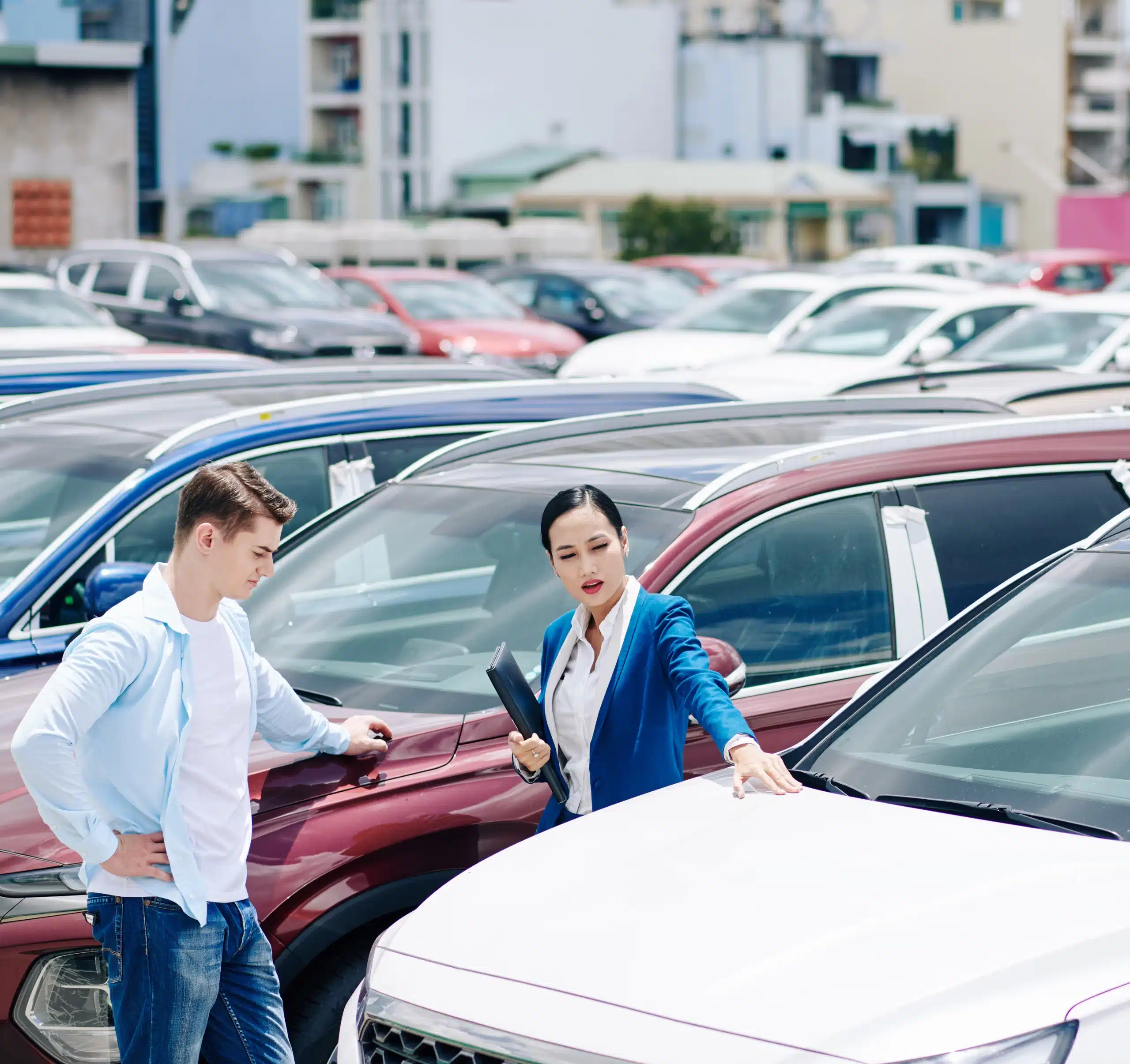 Female dealership manager helping customer to choose a new car