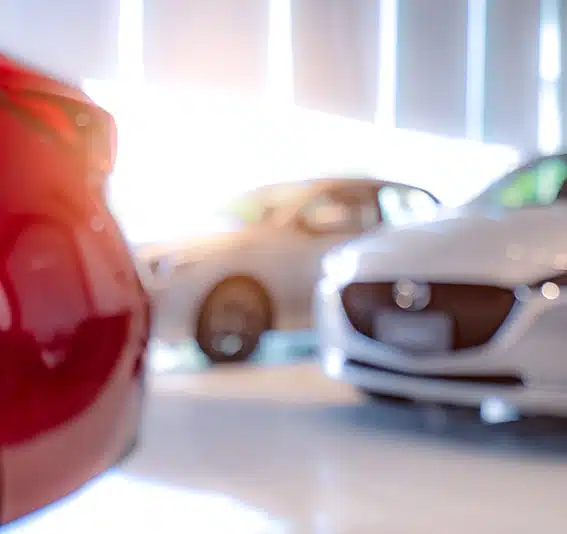 Blurred of white and red car parked in showroom