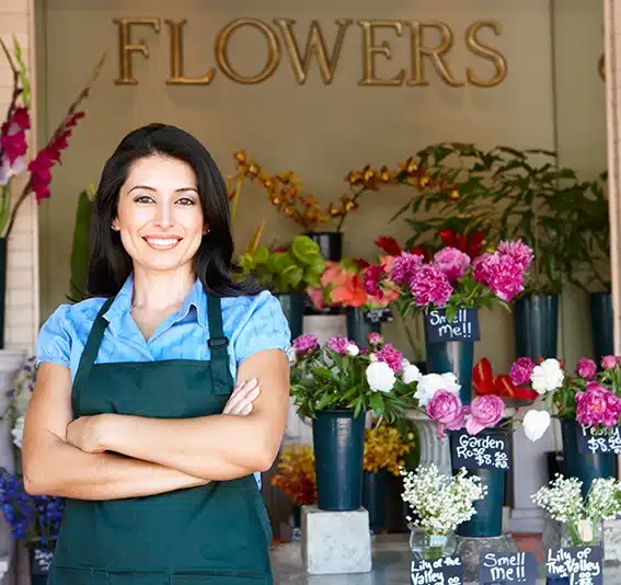 A woman smiling with a flower business