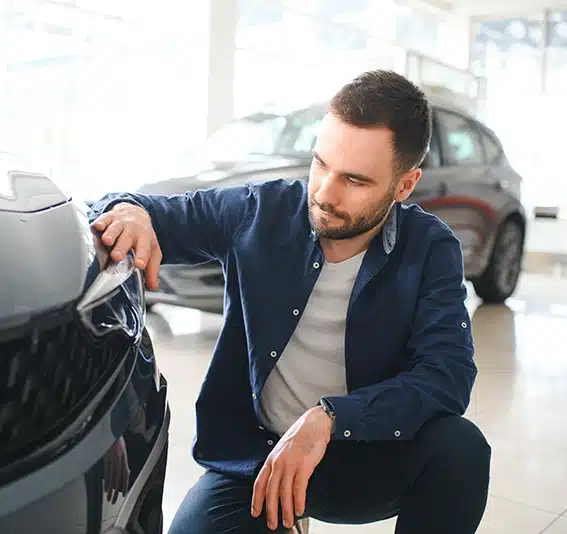 A man is choosing a new vehicle in car dealership