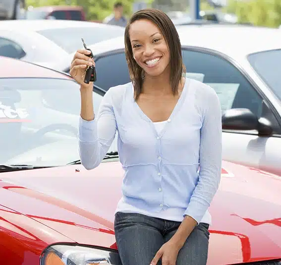 Woman picking up new car from lot