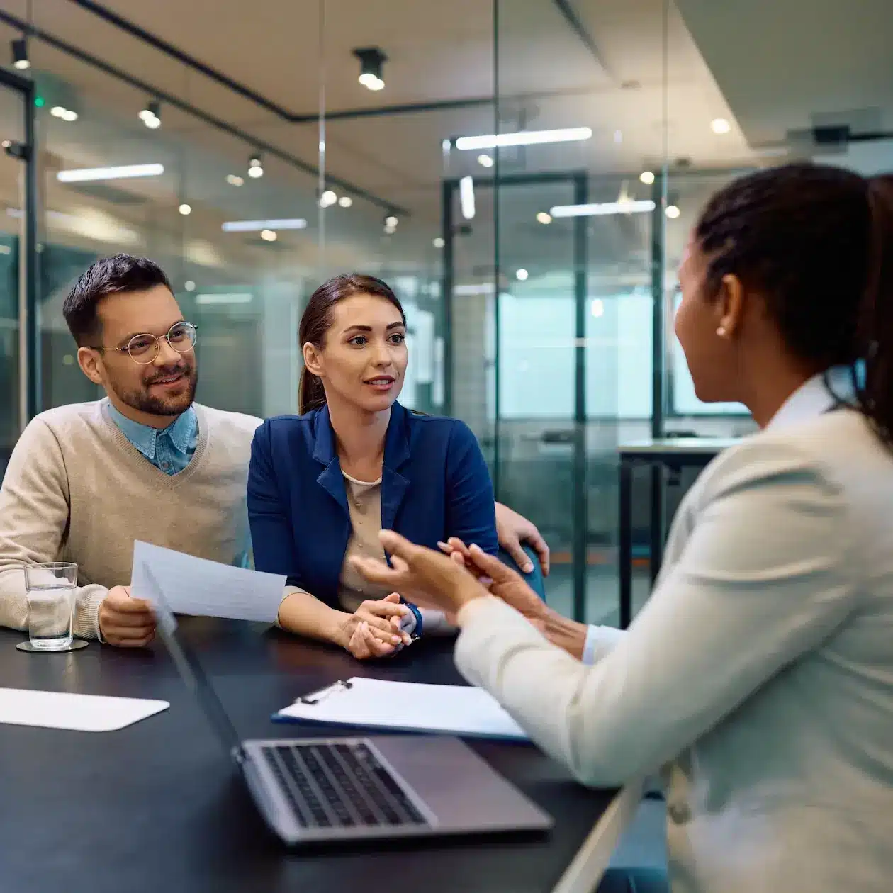 A couple are meeting with a professional loan broker to check on the health of their finances seeking to improve their position