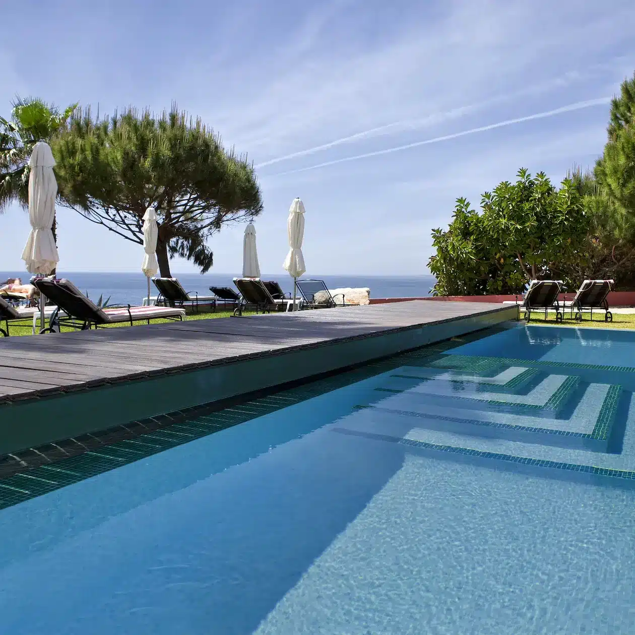A modern pool in a seaside yard during a sunny day