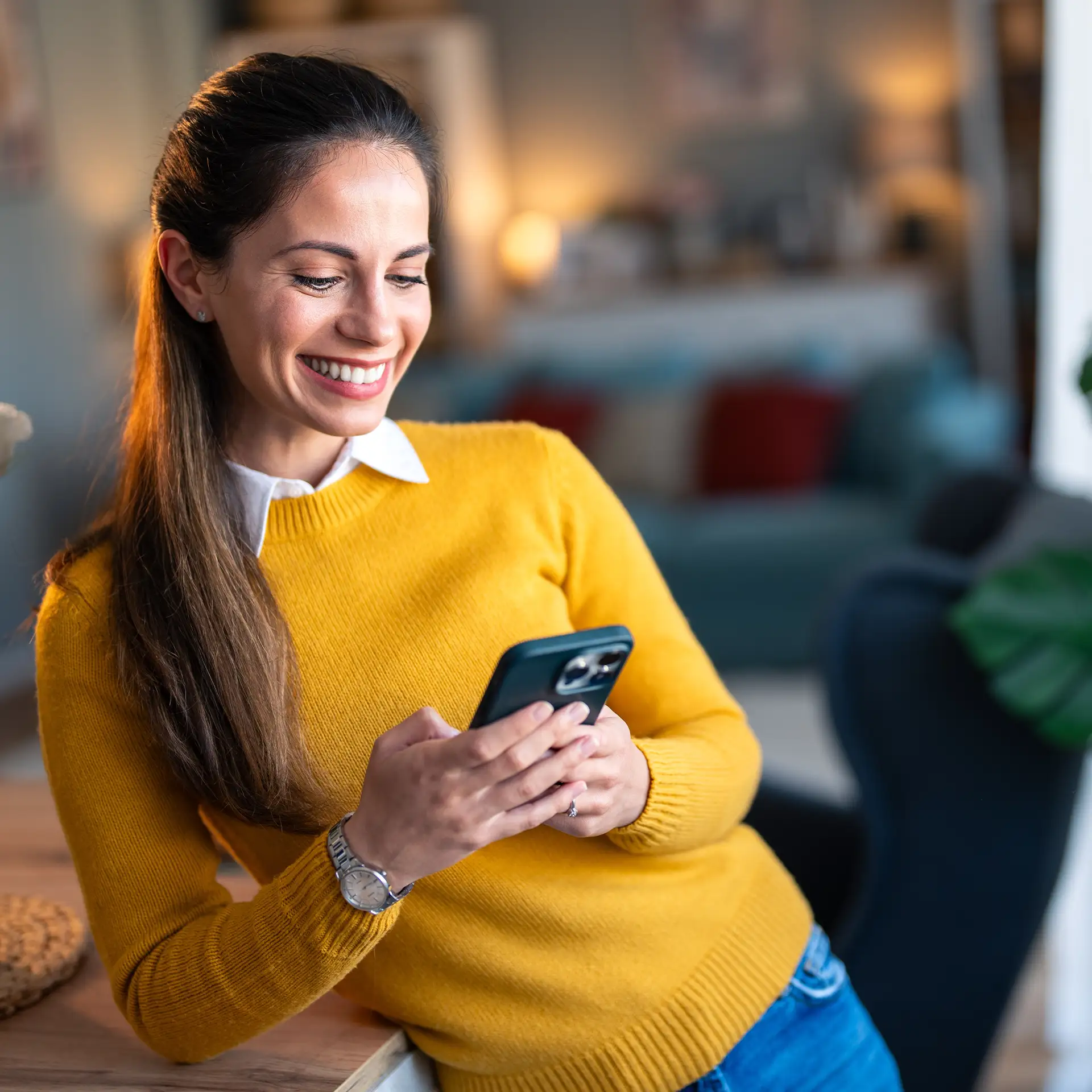 Woman in business casual clothes browsing on a smartphone