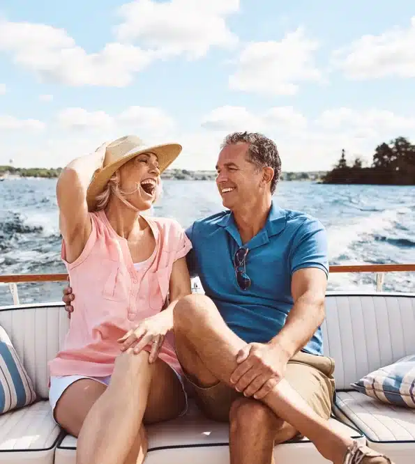 Happy couple enjoying a day on the water aboard their used boat, financed through Jade Finance