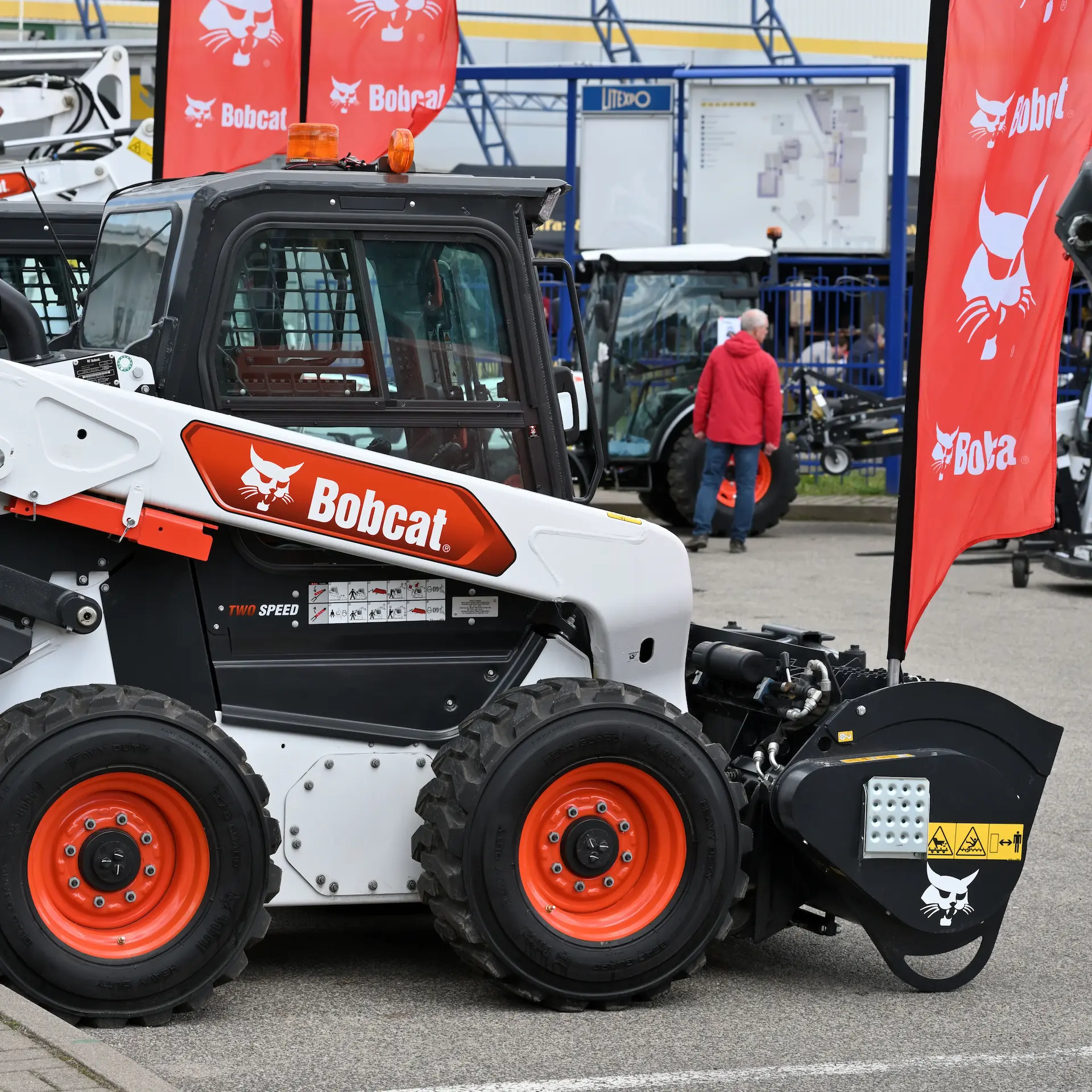 New Bobcat machines lined up at an equipment show.