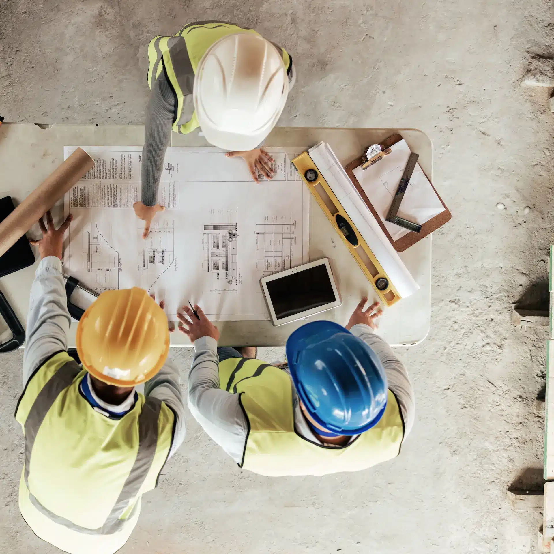 Interior fit out of a commercial office space under planning with the team making notes and using a tablet and calculator to make decisions.