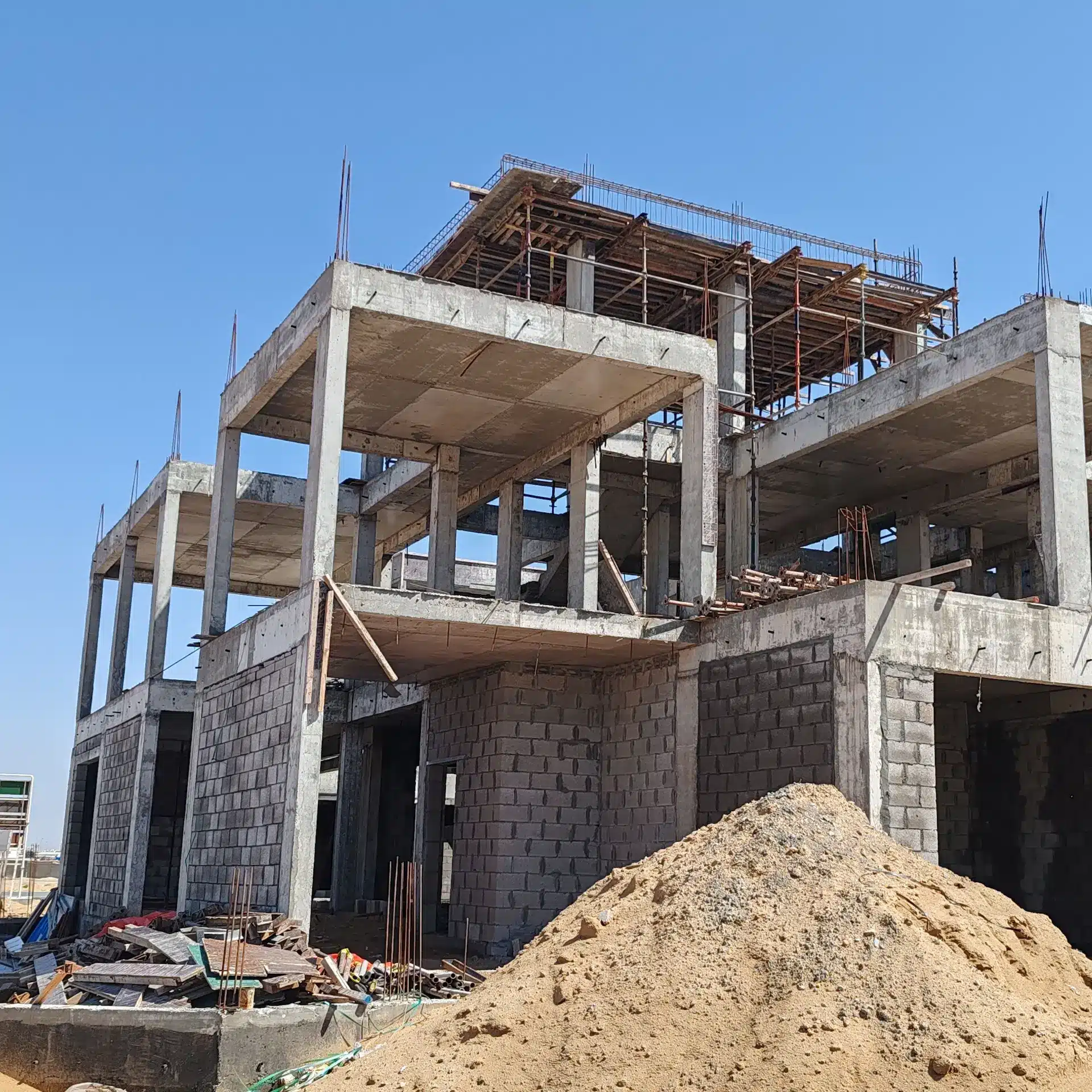 A dual story home under construction using core filled concrete blocks as the main load bearing wall construction method.