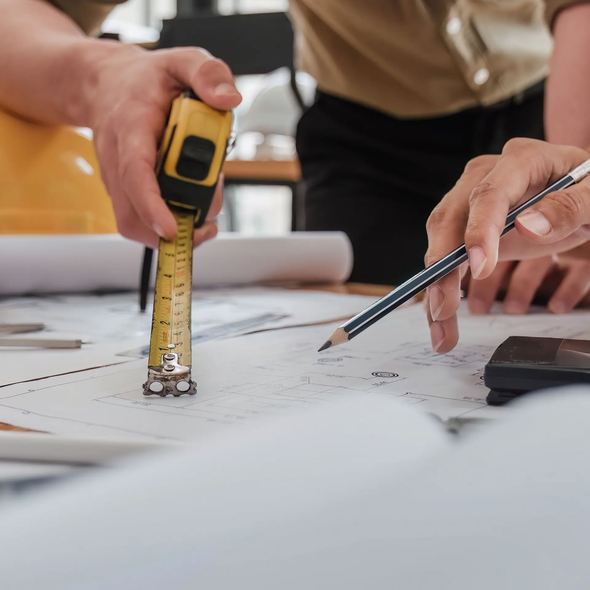 A builder and client are discussing details of the house plan they are working with.