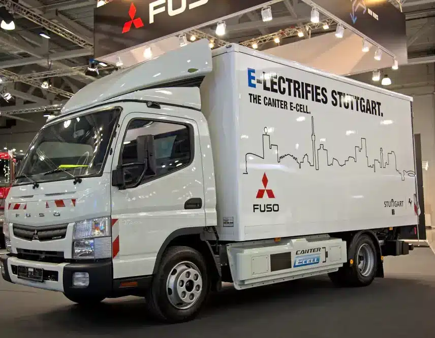Fuso Canter E-Cell truck displayed at an expo, highlighting eco-friendly truck options available through Fuso truck finance at Jade Finance.