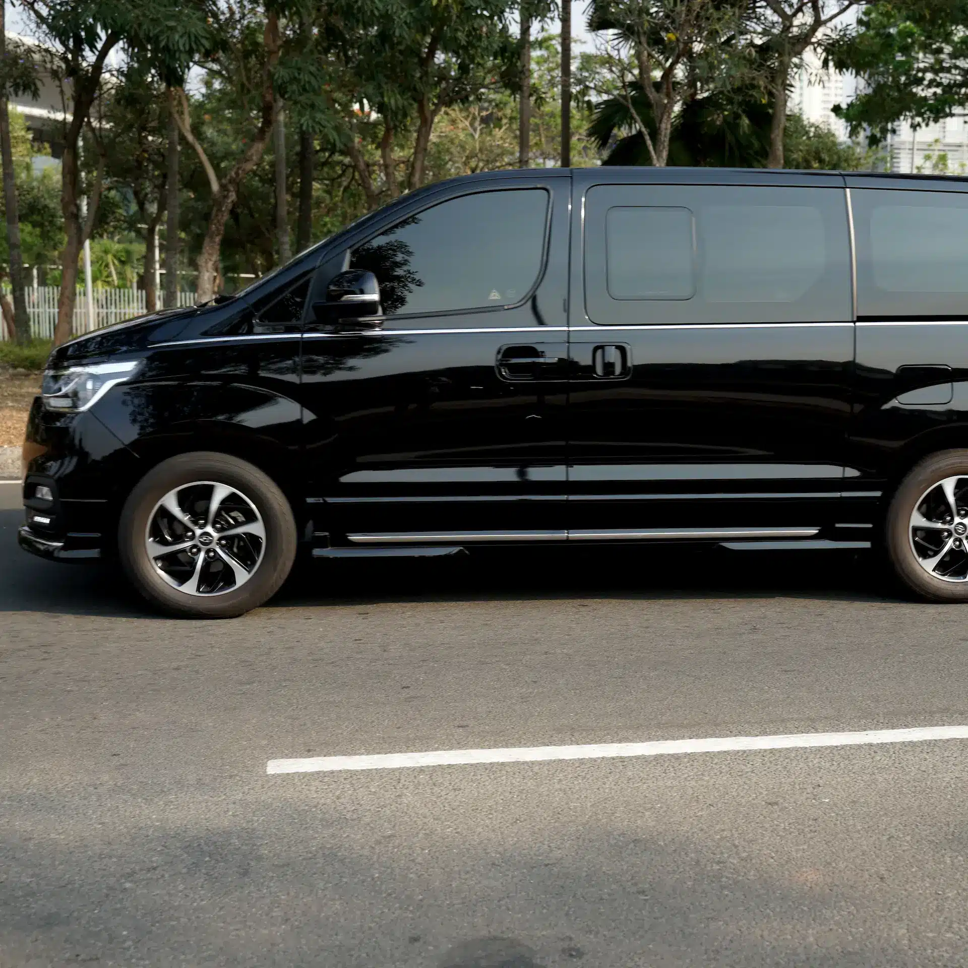 Hyundai black commercial van used for passenger transfers