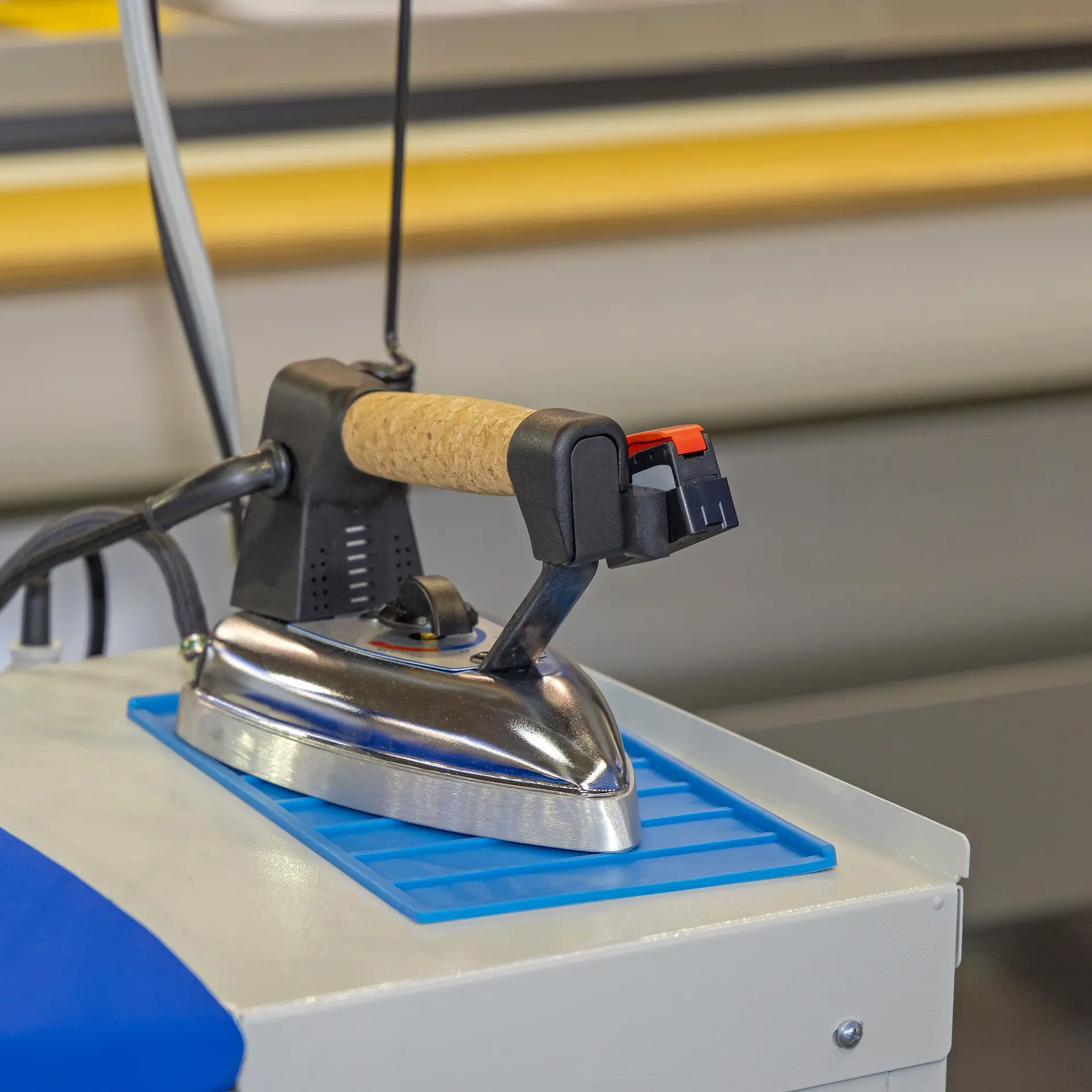 A team iron ready for use in a laundromat.