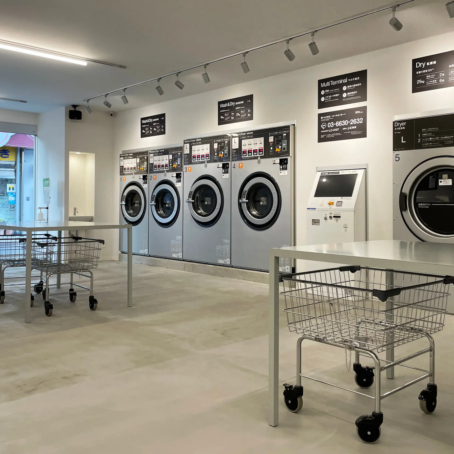 A modern laundromat with commercial laundry equipment ready for use by customers.