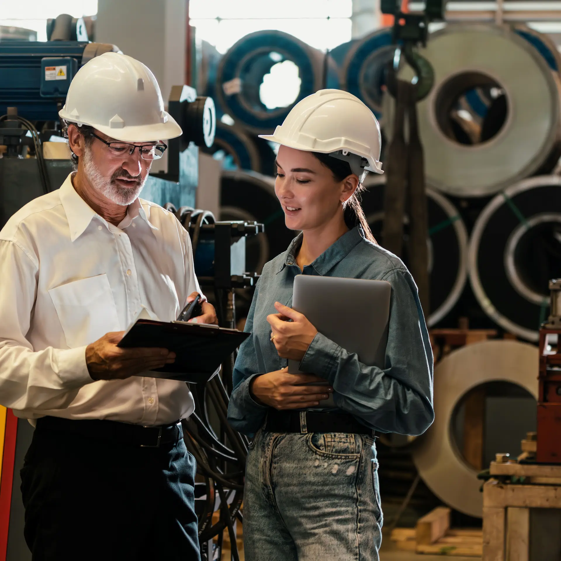 Two manufacturing facility administrators discuss replacing equipment using Jade Finance to source the best interest rates on manufacturing equipment loans.