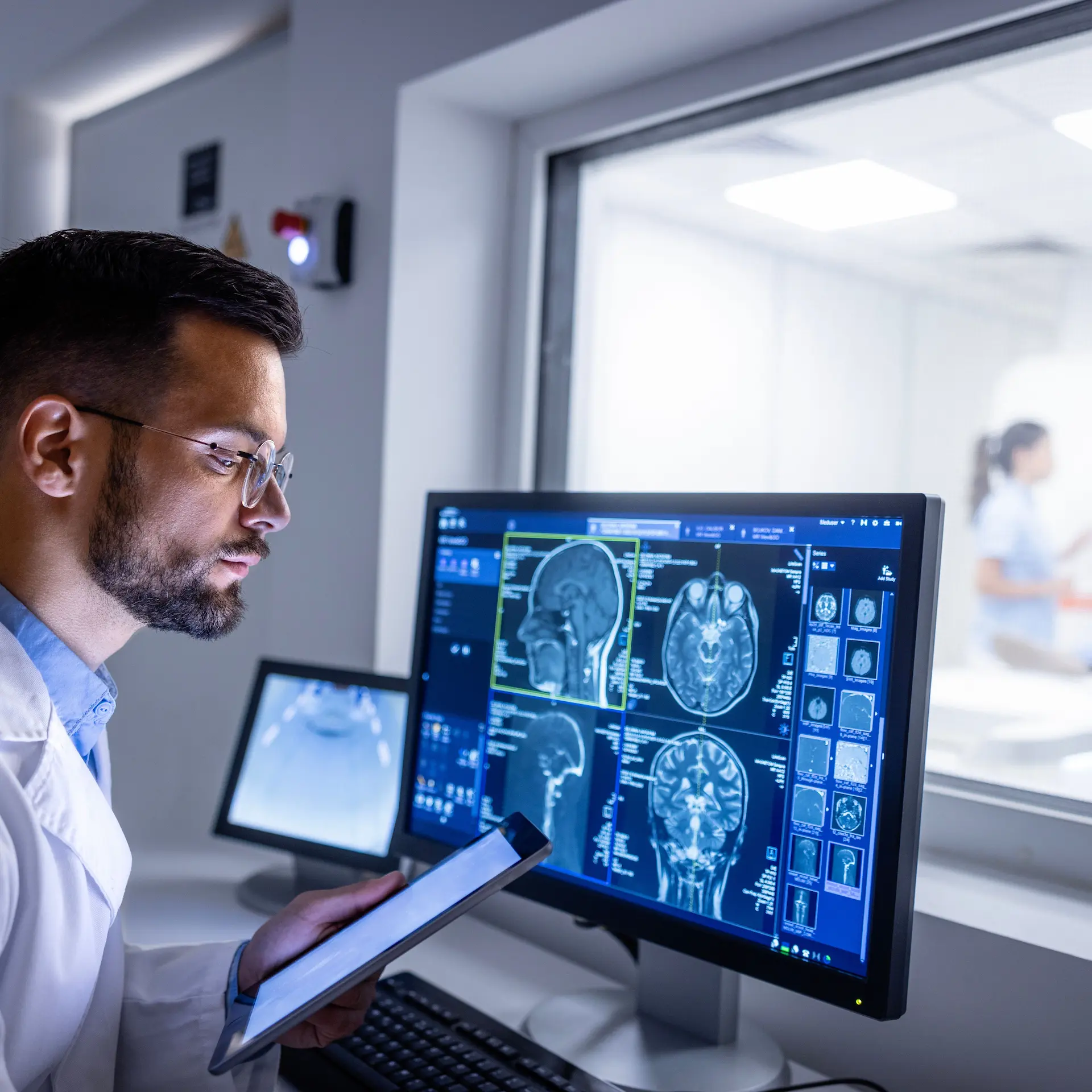 Medical Imaging computer equipment being used by a radiologist checking a patient's scan results.