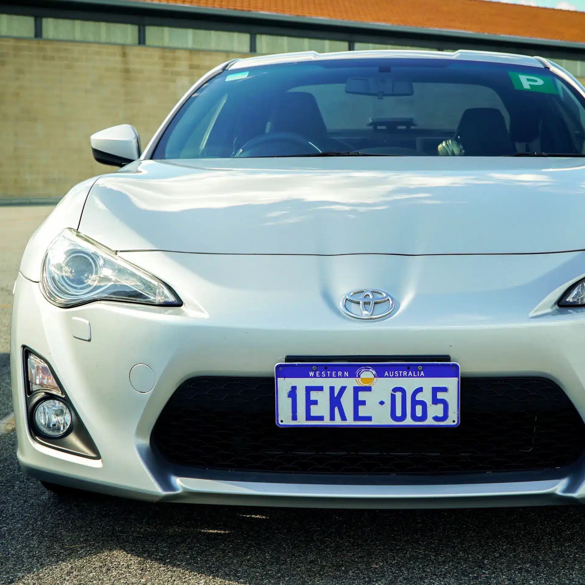 A white Toyota 86 parked facing you