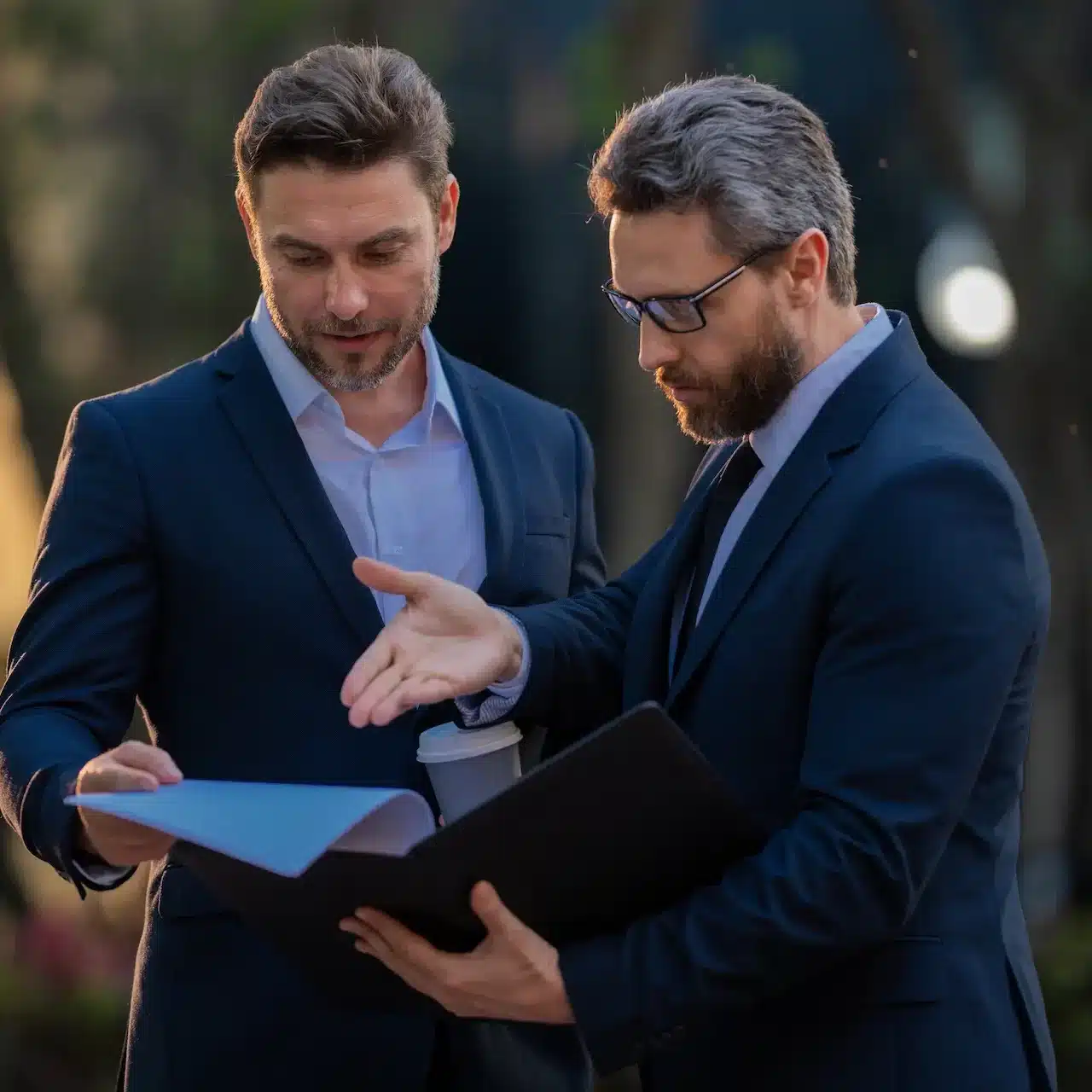 A commercial loan broker meets with his client in a park in Adelaide to talk through finance options.