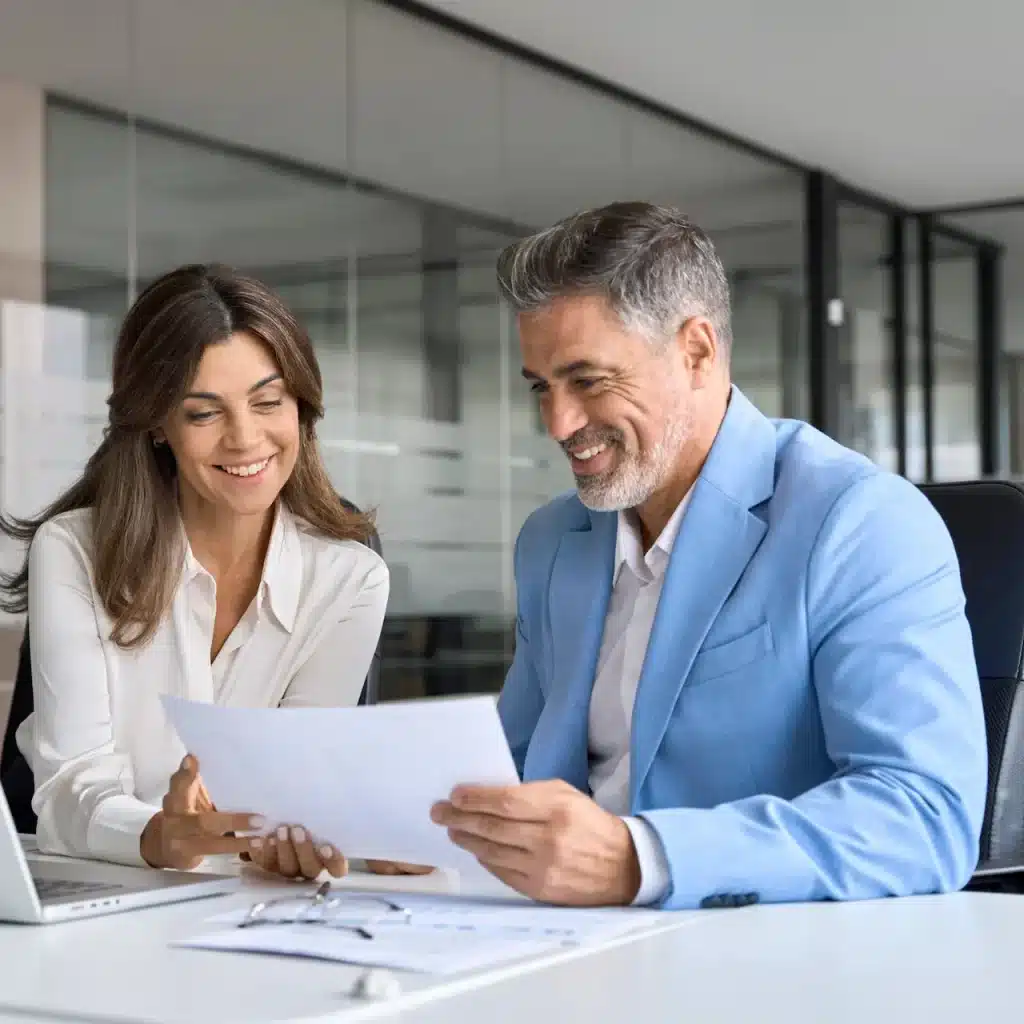 A finance broker meets with her happy client in a Darwin office.