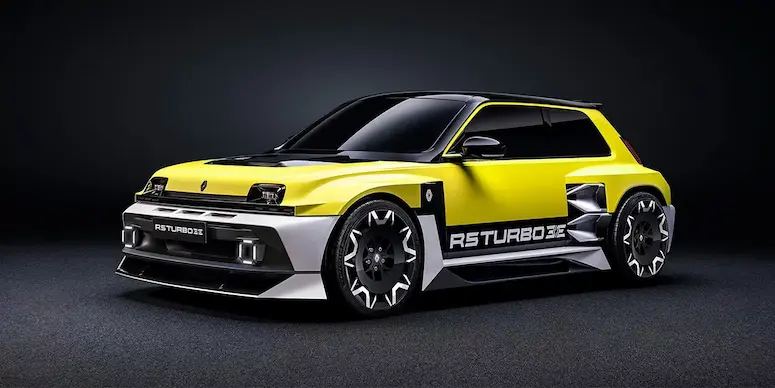 The insane Renault 5 Turbo 3E during a photoshoot in a dark room, with hero yellow and black two-tone livery.