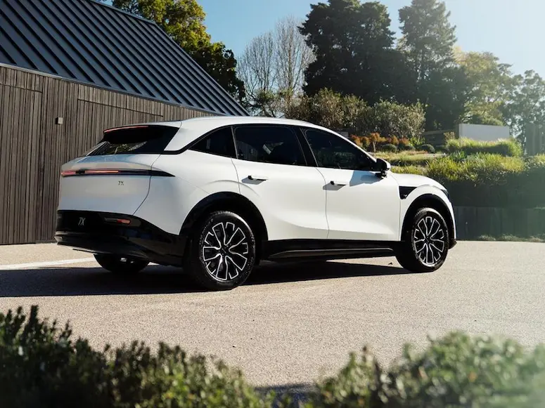 White Zeekr 7X SUV parked outside a modern building, highlighting its sleek design and advanced features.