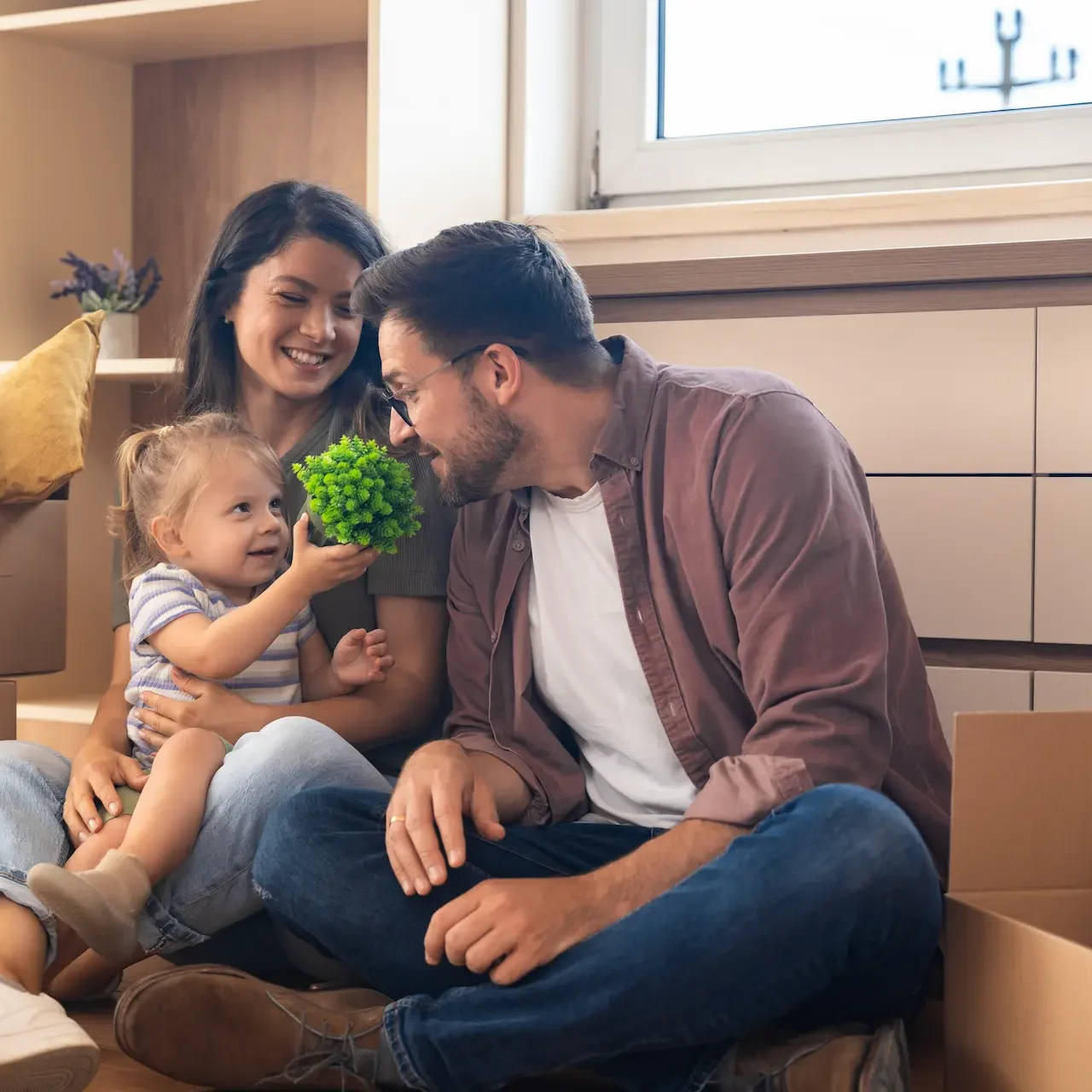 Happy Family Unpacking after Secure Low Home Loan Rates with Jade Finance