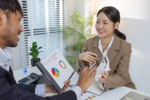 Business professionals reviewing financial data during a consultation to secure the best loans available.