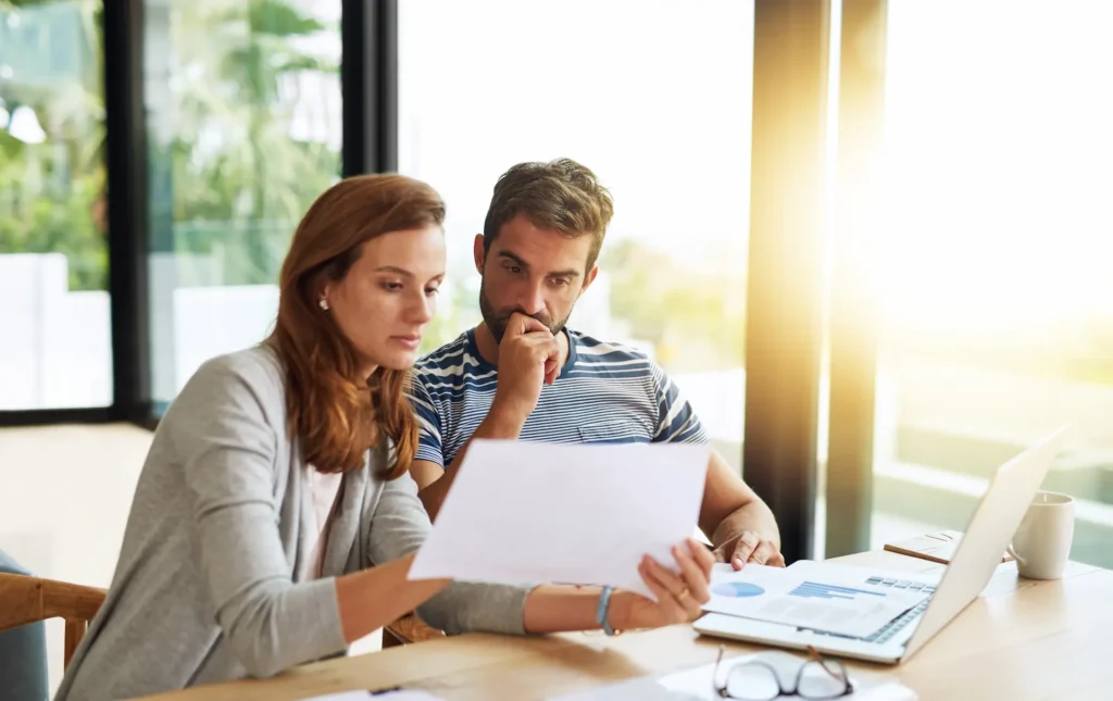 Young couple considering finance for a car after reserve bank rate rises